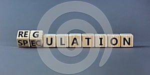 Speculation or regulation symbol. Turned cubes and changed the word speculation to regulation. Beautiful grey table, grey