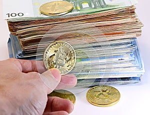 speculator with a bitcoin coin and a pile of many euro banknotes