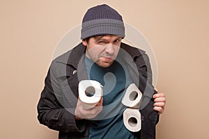 Speculator man holding several roll of toilet paper. Do you want to buy it