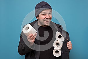 Speculator man holding several roll of toilet paper. Do you want to buy it