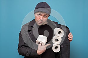 Speculator man holding several roll of toilet paper. Do you want to buy it