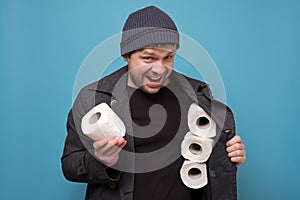 Speculator man holding several roll of toilet paper. Do you want to buy it