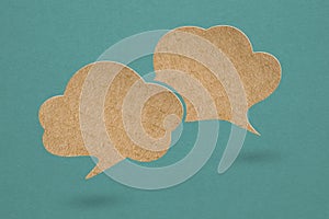 speech bubbles brown cardboard paper cut,  on grunge green background. For message box outline cartoon  illustration design.