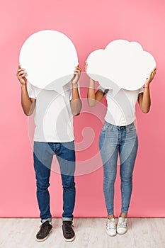 Speech bubbles. Couple holding empty boards, closing their faces