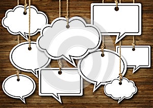 Speech Bubbles Hanging on Wooden Background