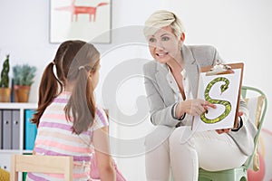 Speech pathologist with young girl