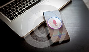 Speech recognition concept - close-up mobile phone with microphone icon and wave sound symbol. Personal voice assistant siri