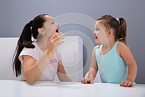 Speech Therapist Helps The Girl How To Pronounce The Sounds photo