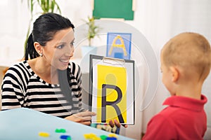 Speech therapist teaches the boys to say the letter R