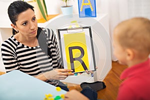 Speech therapist teaches the boys to say the letter R