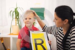 Speech therapist teaches the boys to say the letter R