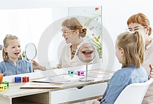 Speech therapist using mirror exercises