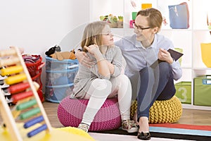 Speech therapist working with child photo