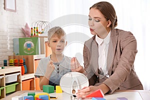 Speech therapist working with little boy