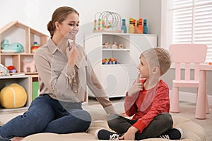 Speech therapist working with little boy