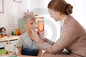 Speech therapist working with little boy