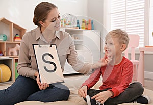 Speech therapist working with little boy