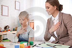 Speech therapist working with little boy