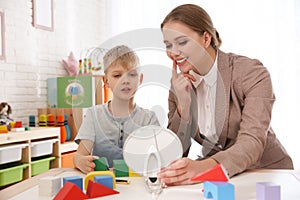 Speech therapist working with little boy