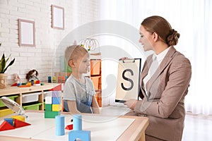 Speech therapist working with little boy