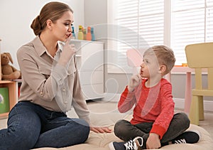 Speech therapist working with little boy