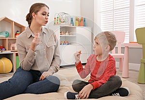 Speech therapist working with little boy