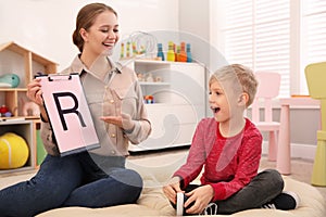 Speech therapist working with little boy