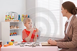 Speech therapist working with little boy