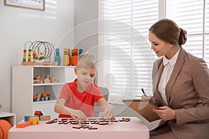 Speech therapist working with little boy