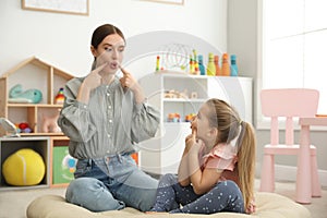 Speech therapist working with little girl