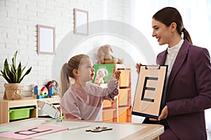 Speech therapist working with little girl