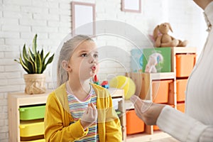 Speech therapist working with little girl