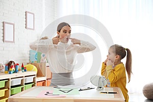 Speech therapist working with little girl