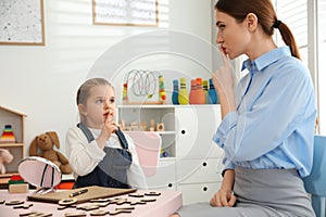 Speech therapist working with little girl