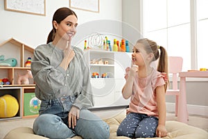 Speech therapist working with little girl