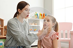 Speech therapist working with little girl