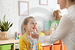 Speech therapist working with little girl