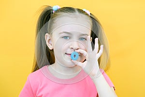 Speech therapy. Toddler girl holding the letter in her hands. Classes with a speech therapist. Girl on isolated yellow background