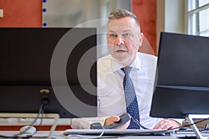 Speechless businessman staring at his monitor in shock