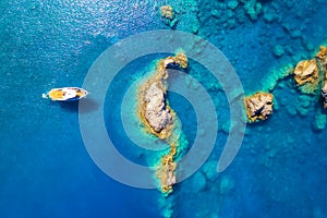 Speed boat in blue sea at sunrise in summer. Aerial view