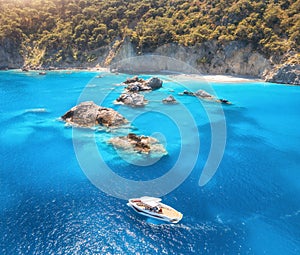 Speed boat in blue sea at sunrise in summer. Aerial view