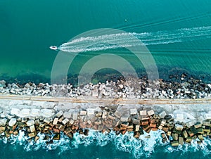 A speed boat and a breakwall aerial view