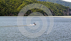 Speed boat crossing river