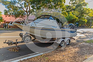 speed Boat Fishing Boat parked on the side of the road on a boat trailer in Western Sydney