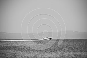 Speed boat. High speed boat in sea, blue sky and mountains on background. Amazing view on white luxury yacht glides on