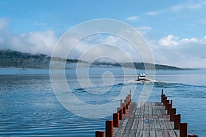 Speed boat departing from dock photo