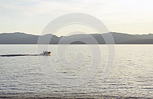 Speed boat making waves at sunset in Lake Tahoe