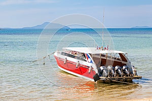 Speed boat moored to the pier of rawai beach in thailand to transport tourists to the phi phi islands