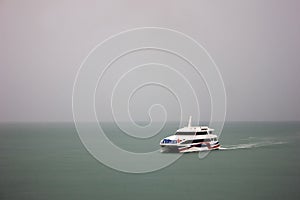 Speed boat sailing in fog, rain,Travel and transportation.