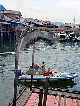 The speed boat is departing from the port of the new village, Balikpapan to the port of Penajam, Indonesia